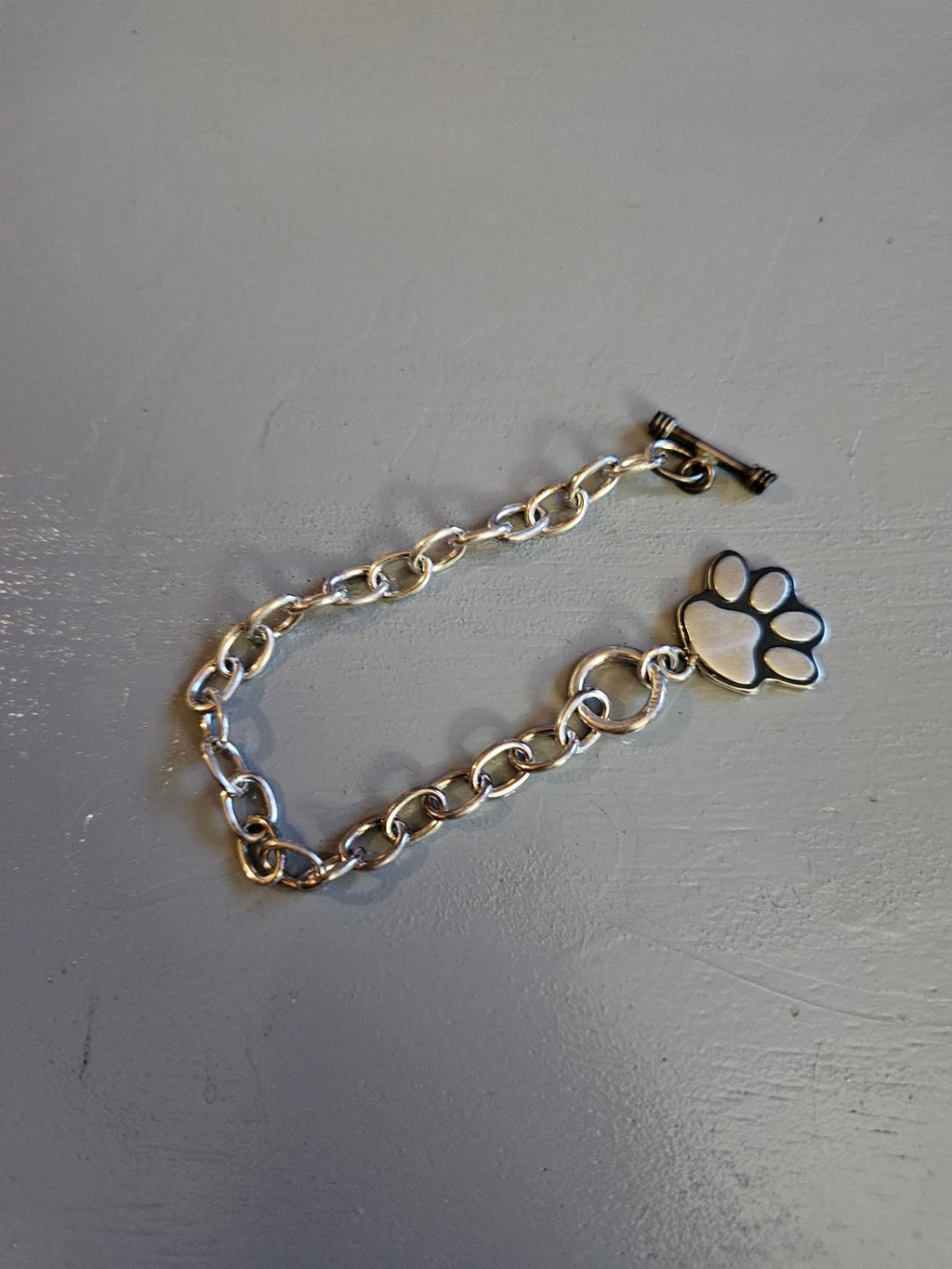 Chain Reaction: Paw Print Charm Bracelet for Fierce Wrist Action